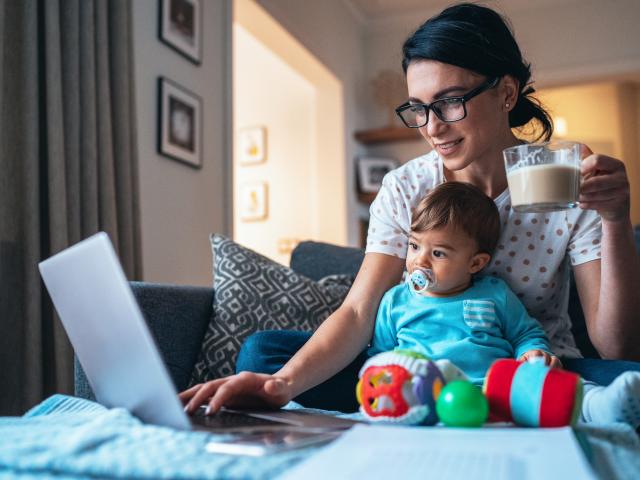 An adult learner studies for her master's program while caring for an infant