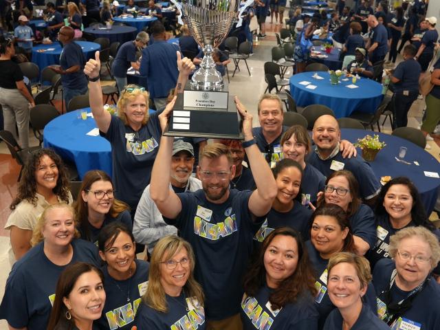 Kean's College of Health and Human Services poses with the Founders Day trophy