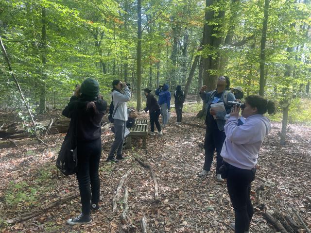 Students practicing field identification skills using binoculars. 