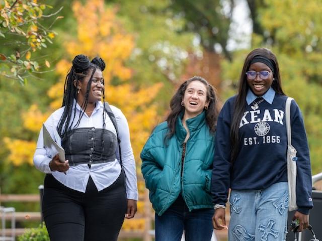 A group of Kean students walk along Cougar Walk on a Fall day 
