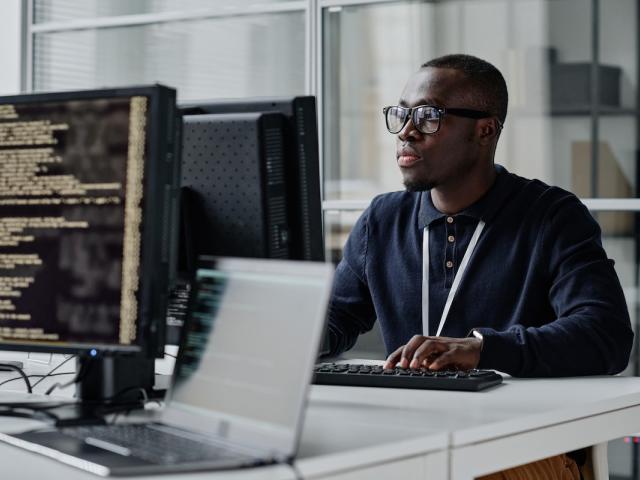 A cybersecurity analyst at his work station 