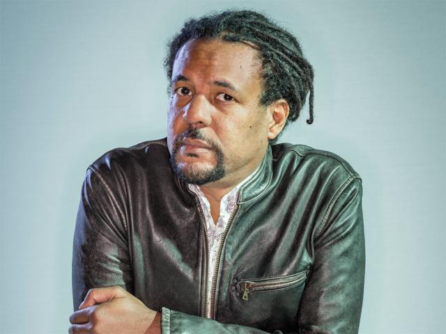 Headshot of Colson with crossed arms and a black jacket