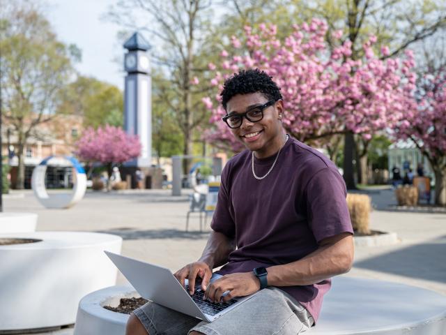 A Kean student studies on the Miron Student Center patio