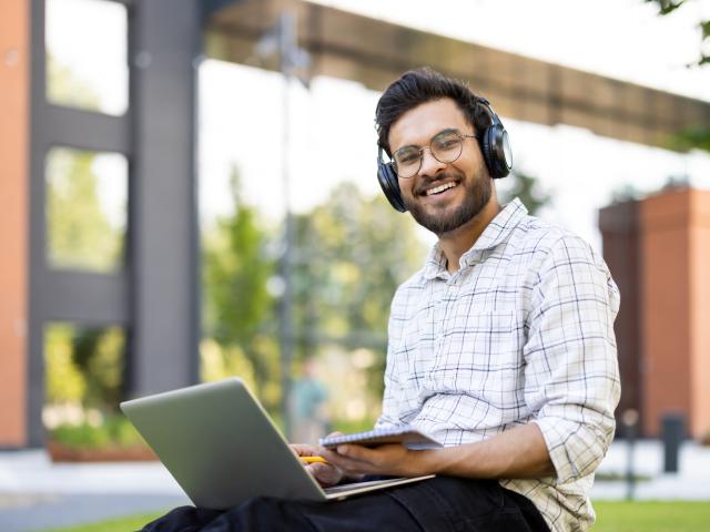 An online student completes his coursework outside