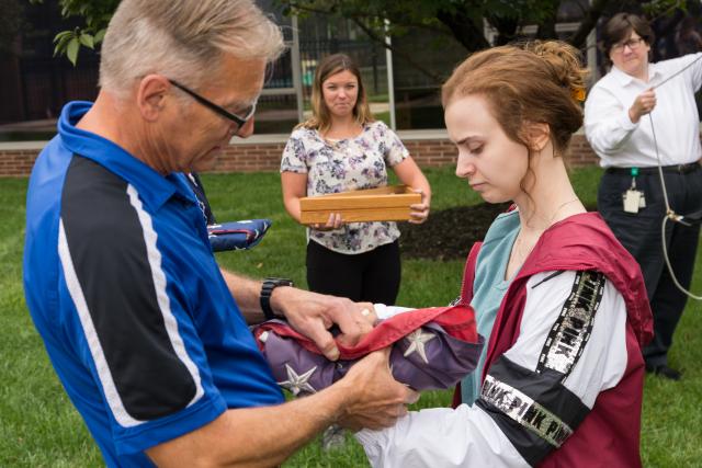 A flag that flew over Ground Zero is prepared to be raised at Kean University.