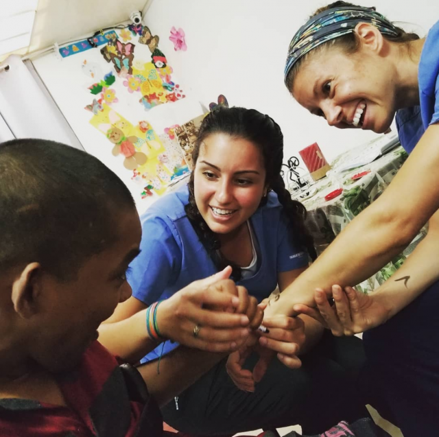 Two Kean occupational therapy students work with a client