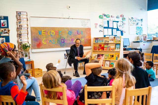 Kean President Dawood Farahi reads to a pre-school class on campus.