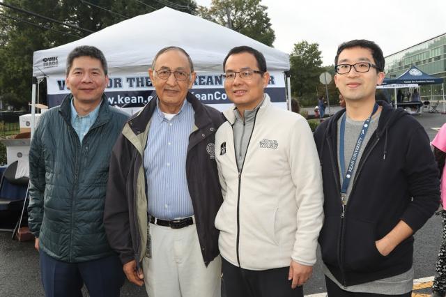 Dr. Farahi stands poses for a picture with three other gentlemen. 