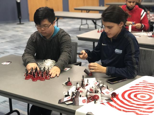 Two students put together small salvation army bells