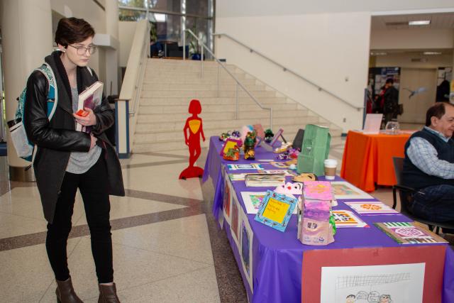 A Kean student looks at the art display of children's artwork that were victims of domestic violence.