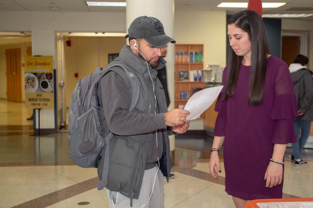 Kathryn Lynch, director of community support services at YWCA speaks with a Kean student about the resources available through the YWCA.