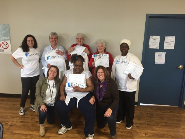 Students and patients pose together with certificates for completing the Let's Go program