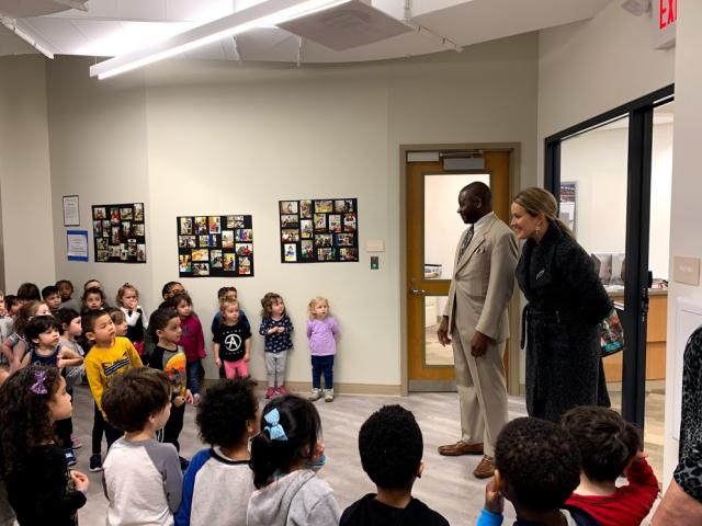 Pittman and Wolfe speak to a hallway full of children from the Child Care Center. 