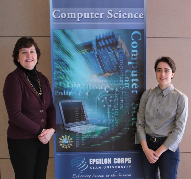 Photo of Dr. Morreale (Left) and Isabel Morias (right) standing next to a computer science banner