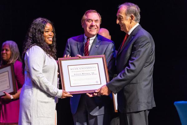 Lovely Randle receives the Young Adult Activist Award from Assemblyman Craig J. Coughlin and Dr. Dawood Farahi