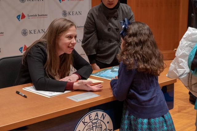 Clinton excited talks with a young girl at her meet and greet. 