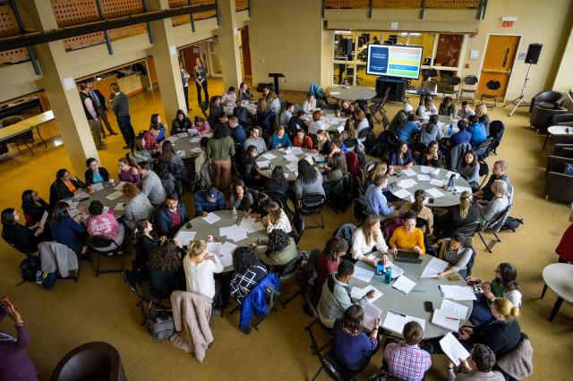 A full house of people sit at the tables 