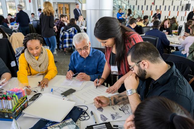 People work together at a table during the conference. 