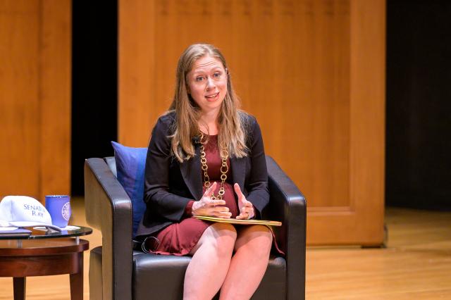 Clinton speaks on stage at Enlow Recital Hall. 