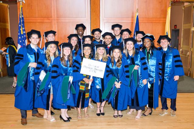 The first class of Doctor of Physical Therapy students poses at commencement.