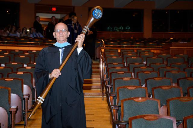 Professor Patrick Ippolito starts the procession, carrying the Kean mace.