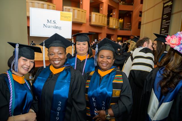 Kean students receiving a master's degree in nursing pose together.