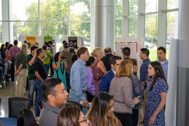 Proud family members, many toting cameras, filled the atrium at the N.J. Center for Science, Technology and Mathematics at Kean, to watch students presentations.