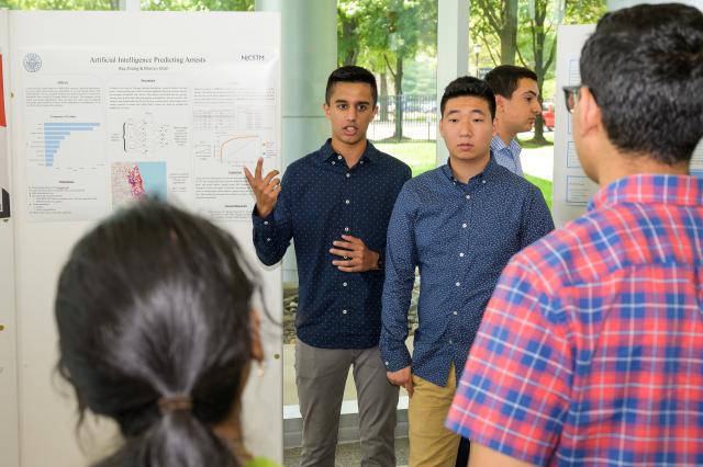 Students Manan Shah of Edison, and Ray Zhang of East Brunswick, present their research.