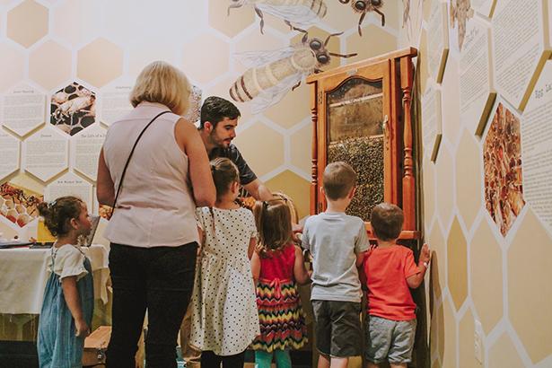 Kean student Mario Cunha teaches a group of children about bees.