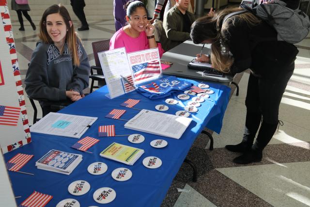 Two student tablers smiling during voter registration tabeling