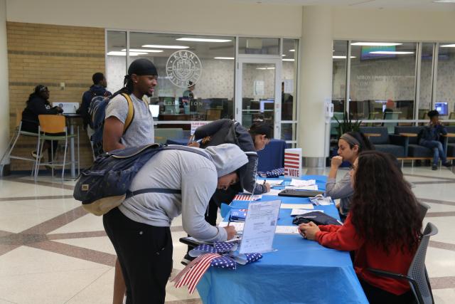 Students register to vote at a Kean University event.