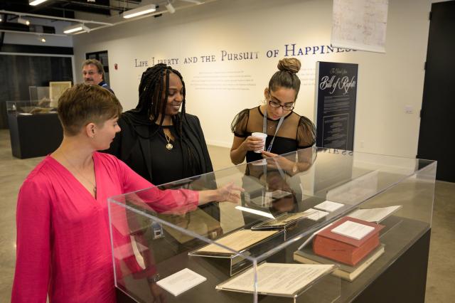 This is an image of Erin C. Alghandoor with guests in LHAC Gallery