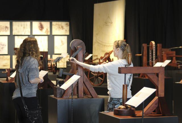 This is an image of guests interacting with Da Vinci's inventions.