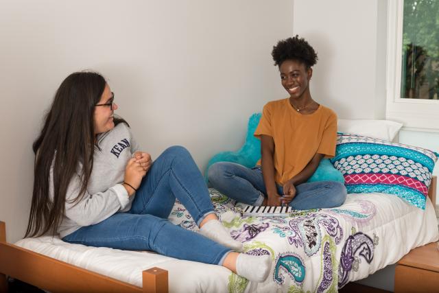 Roommates laugh in a Residence Hall room