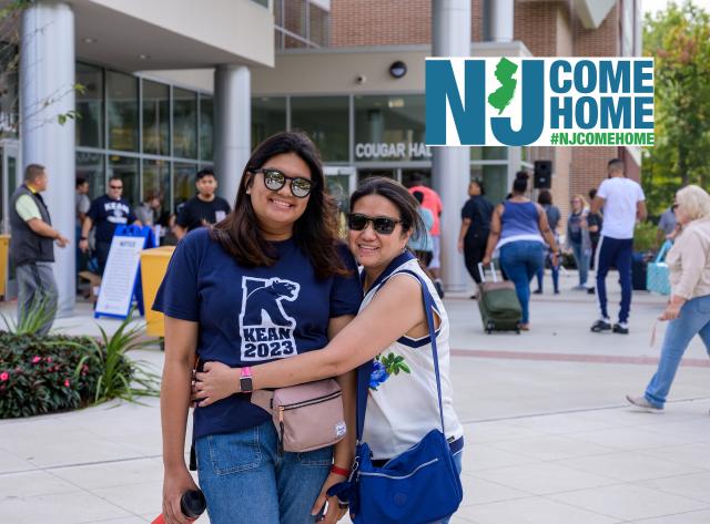 Mother embraces daughter outside of Cougar Hall. 