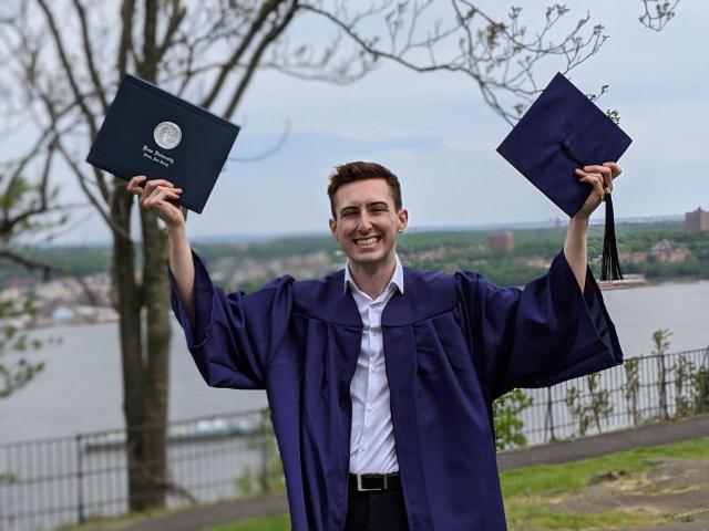 kean grad 2020 guy with arms up