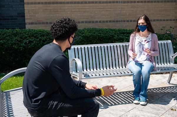 Kean students converse at a distance on the Miron Student Center patio