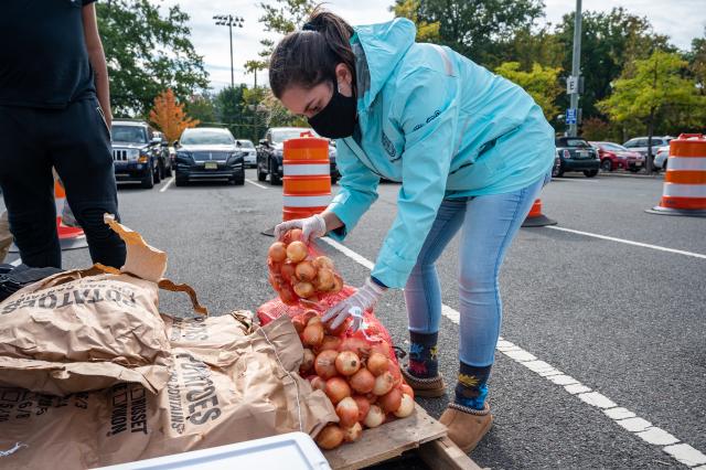 Student carrying food to assist in emergency food distribution on campus. 