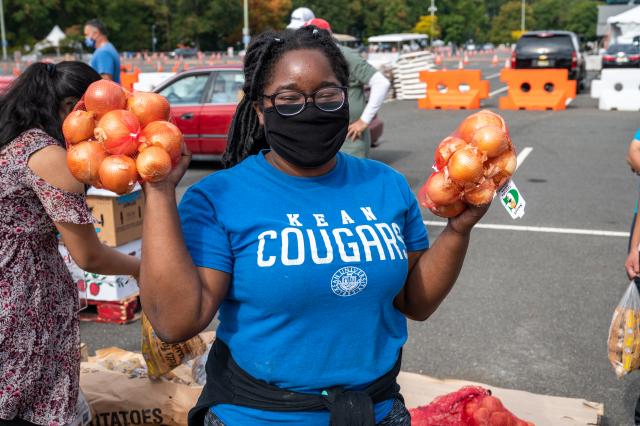 Student carrying food to assist in emergency food distribution on campus. 