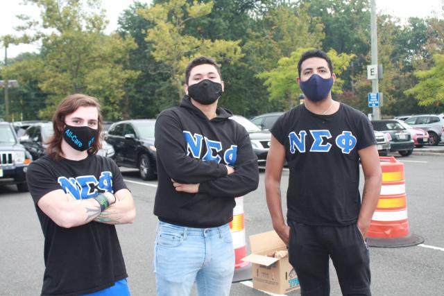 Students posing for a photo at the emergency food distribution on campus.