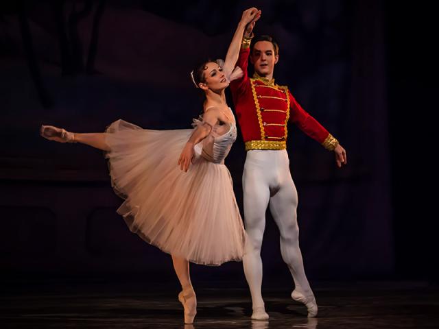 Female Ballerina and Male Ballet Dancer dancing on stage.