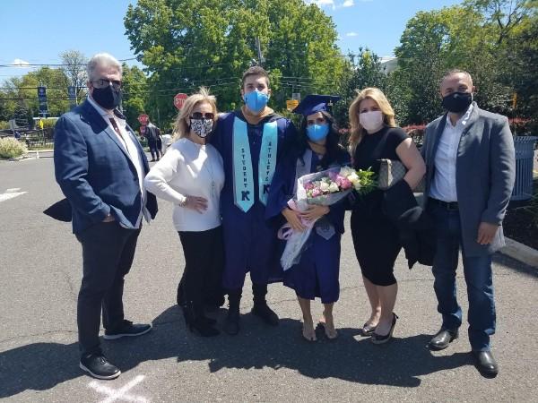 Class of 2021 and high school sweethearts Kayla Alves and Jake Santos with their families at Kean Commenent