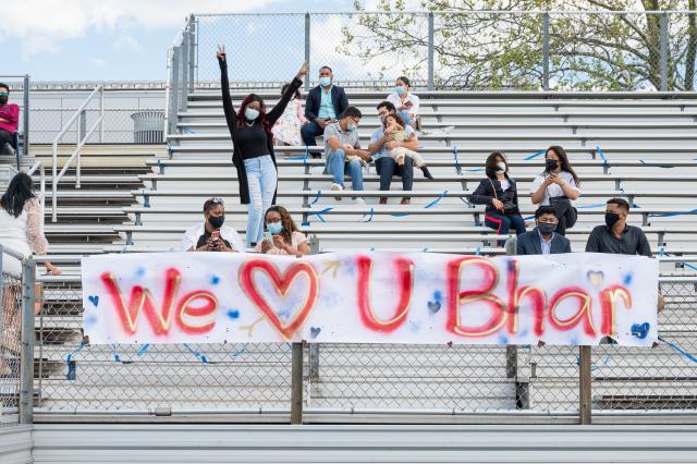 Family celebrates grad in the stands with banner