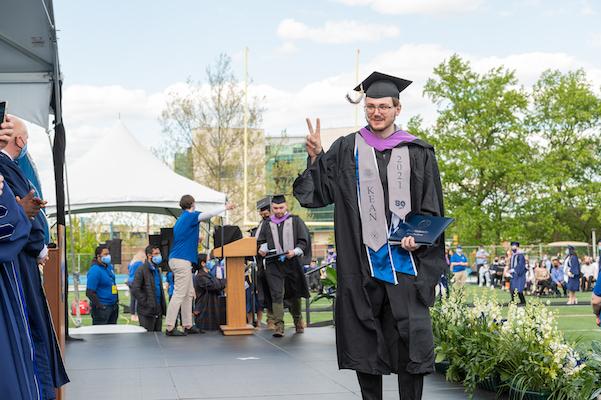 Grad gives crowd the peace sign