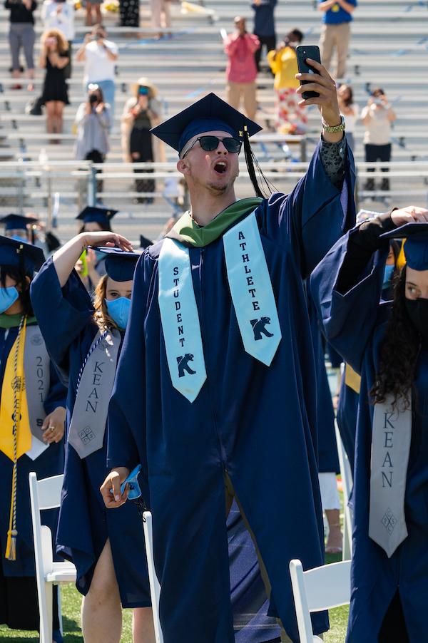 Student athlete takes a graduation selfie