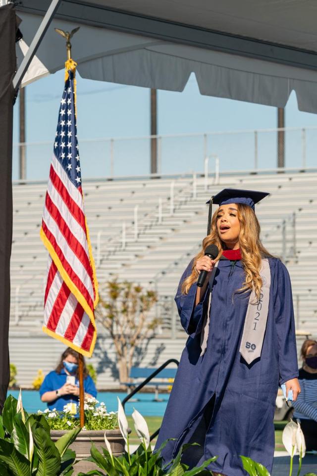 Graduating student sings the Star-Spangled Banner