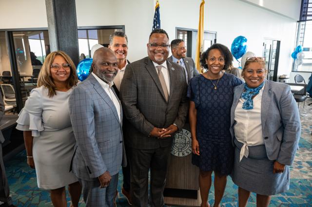 Dr. Lamont Repollet, Kellie Ledet and Dr. Sancha Gray pose for a picture with speakers from the BID Small Business Conference
