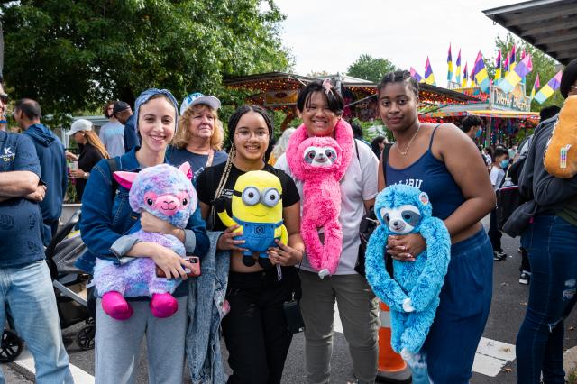 A group of attendees posing with their prizes at Homecoming 2021. 