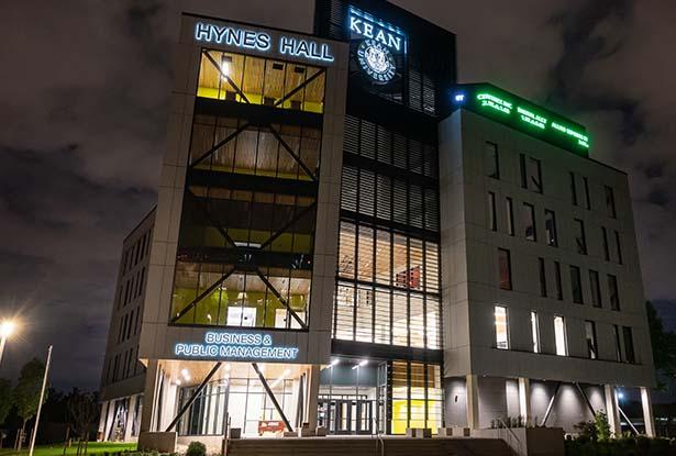 Kean's Hynes Hall at Night, with an illuminated ticker running across one side.