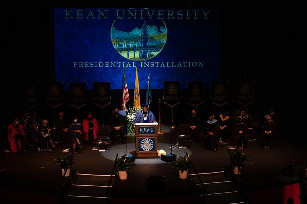 View of stage with platform guests and Dr. Repollet giving his Installation Address at the podium.